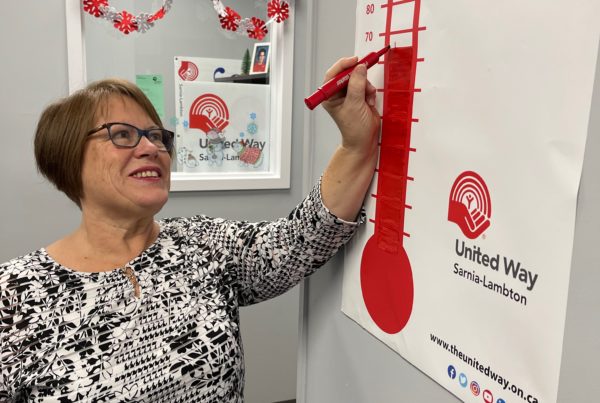 Campaign chair Vicky Ducharme updated the United Way thermometer.