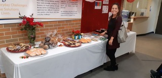 Jasmine Davis, a PSW worker with the United Way funded Family Counselling Centre looks over the bake good table the office organized to raise money for the United Way campaign