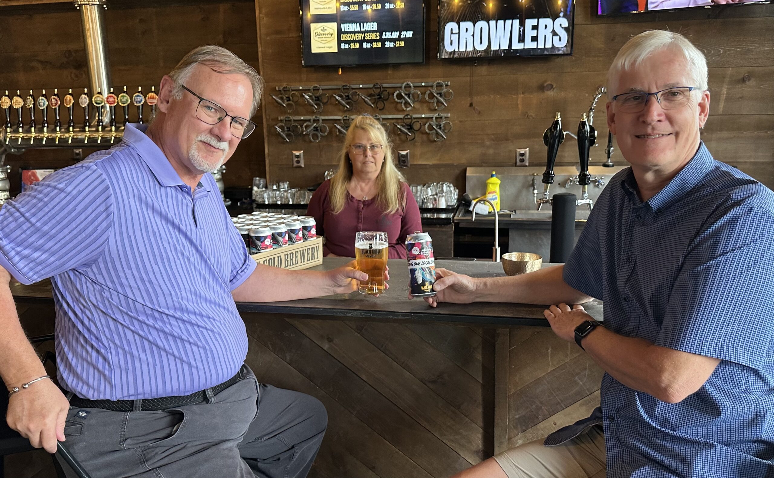 Former United Way board member, Al McChesney enjoys a cold, United Way branded beer with current United Way board member Alan Blahey